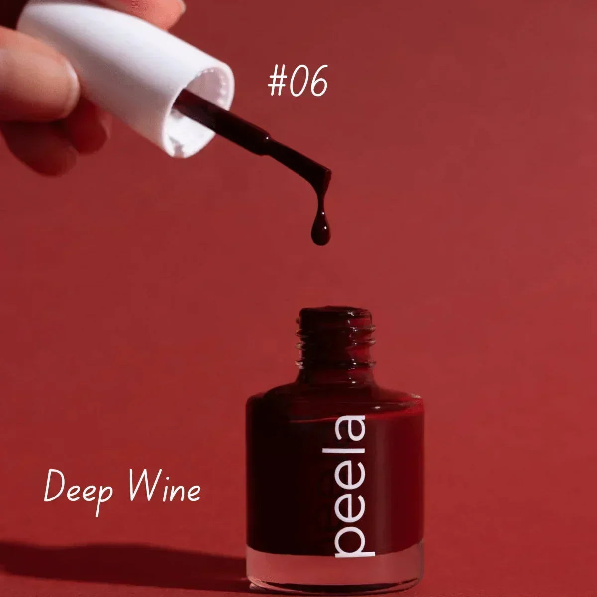 Peela #06 Deep Wine peelable nail polish dripping from brush, rich red shade