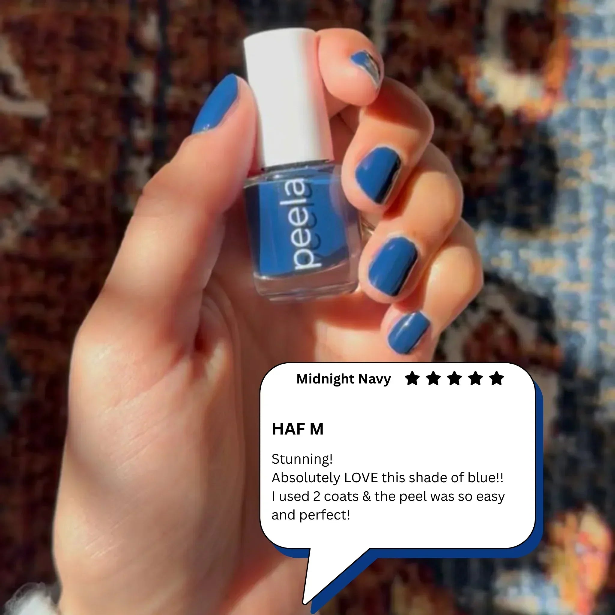 Hand holding peelanails Midnight Navy peelable nail polish with blue manicured nails and review.