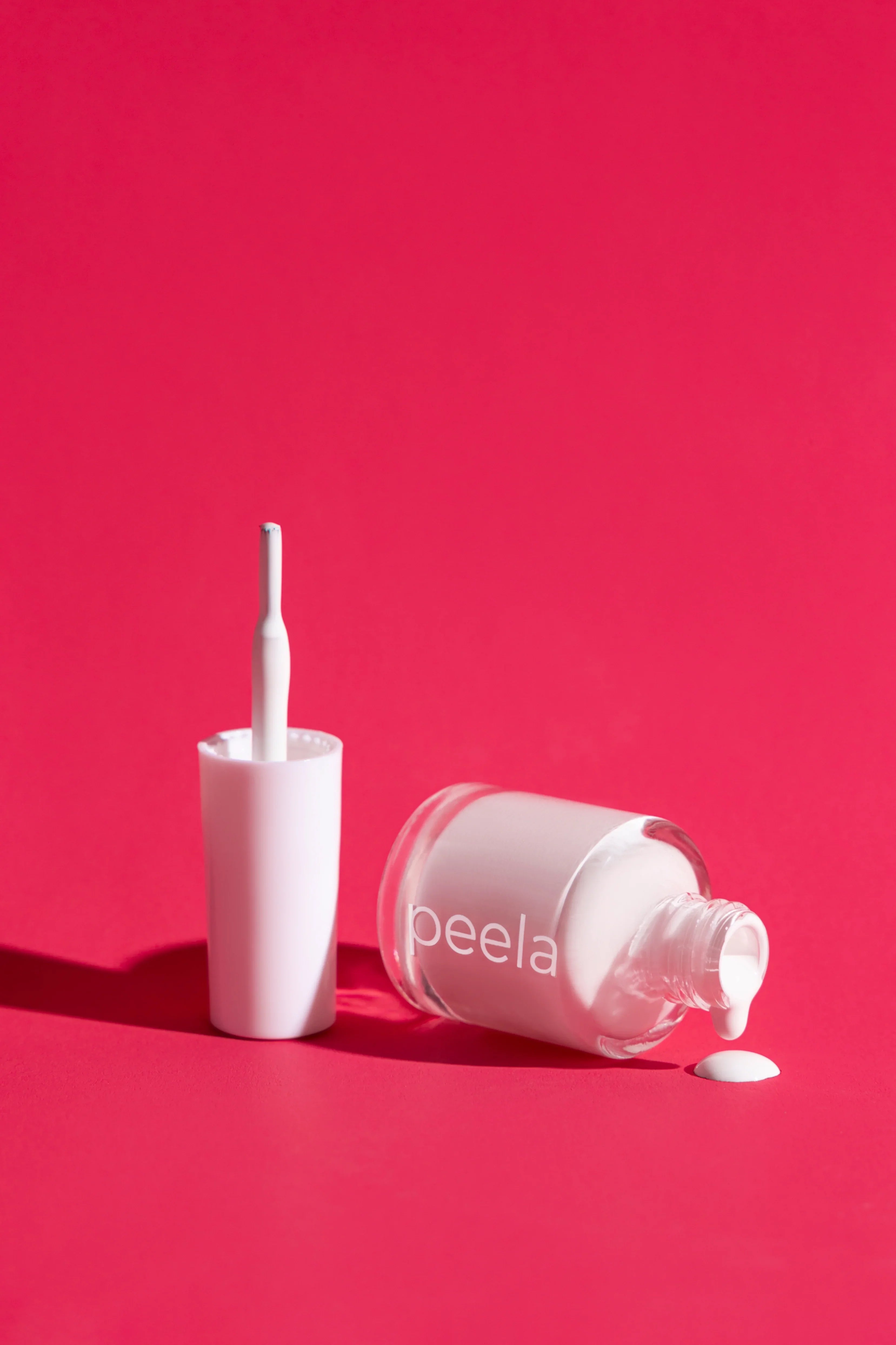peelanails Pure White peelable nail polish bottle with brush and spilled polish