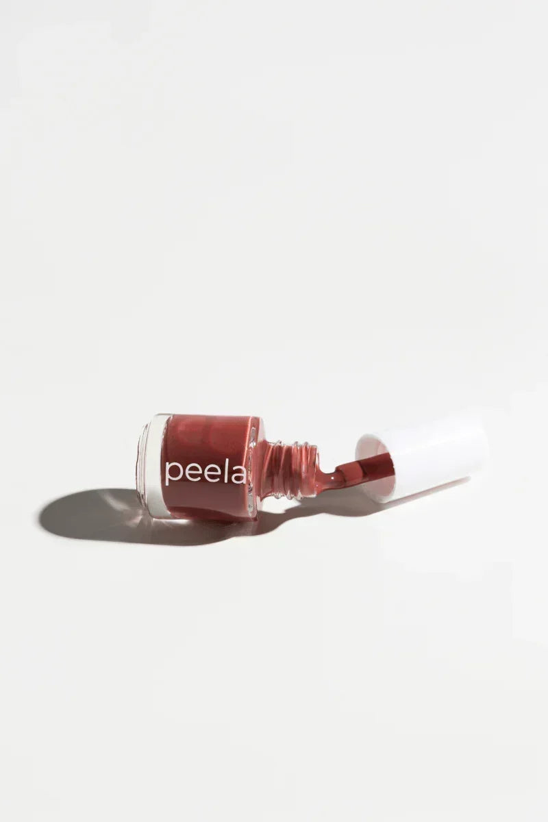 Peelanails peelable nail polish bottle in rose shade with open brush