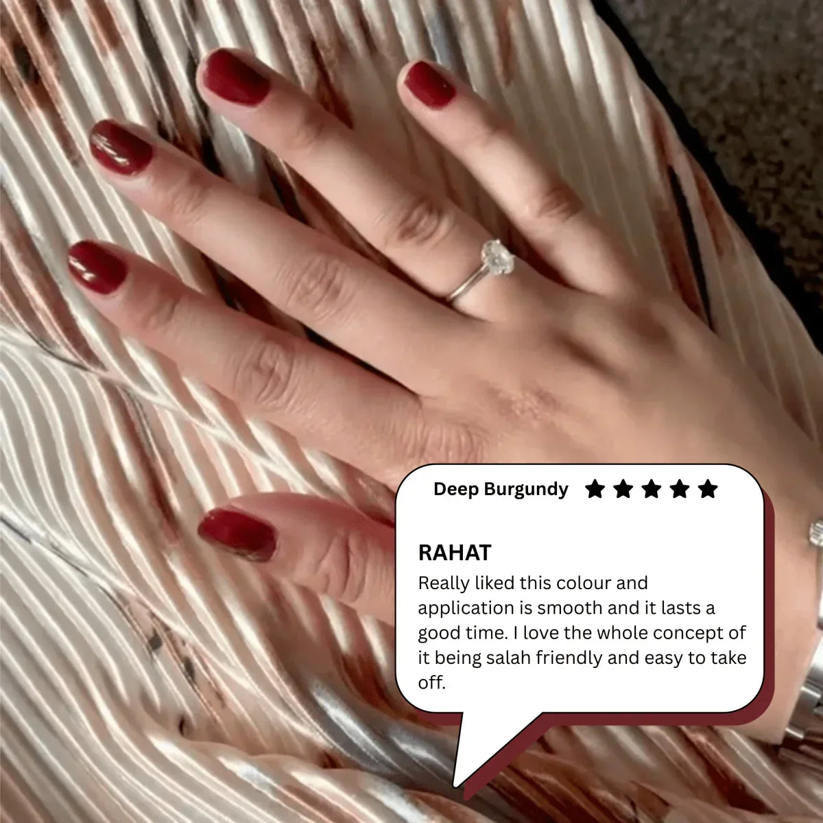 Hand with Deep Burgundy peelable nail polish and a ring, customer review highlights smooth application and easy removal