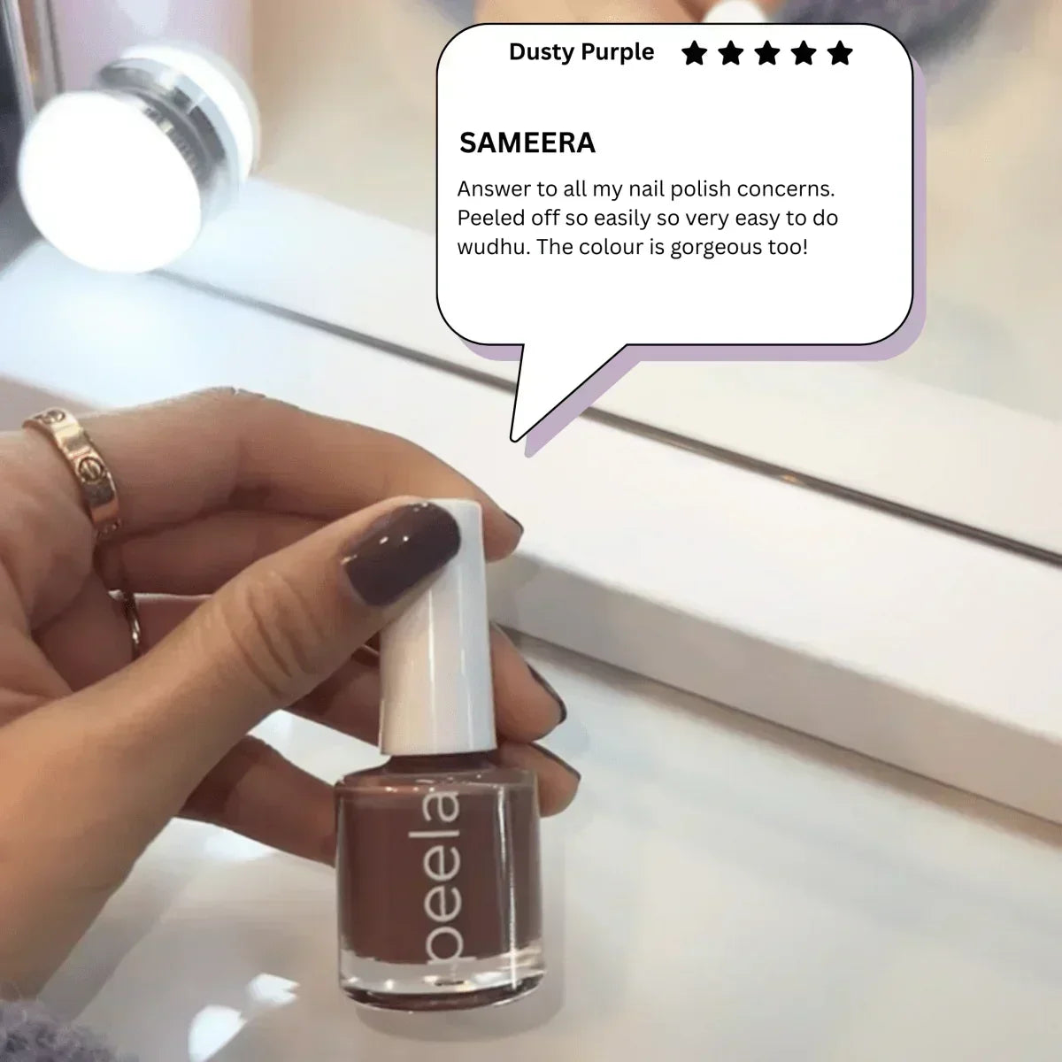 Dusty Purple peelable nail polish bottle held in hand, showcasing easy peel-off formula and rich color
